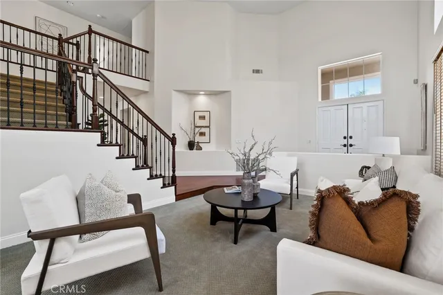 a dining room with furniture a chandelier and a window