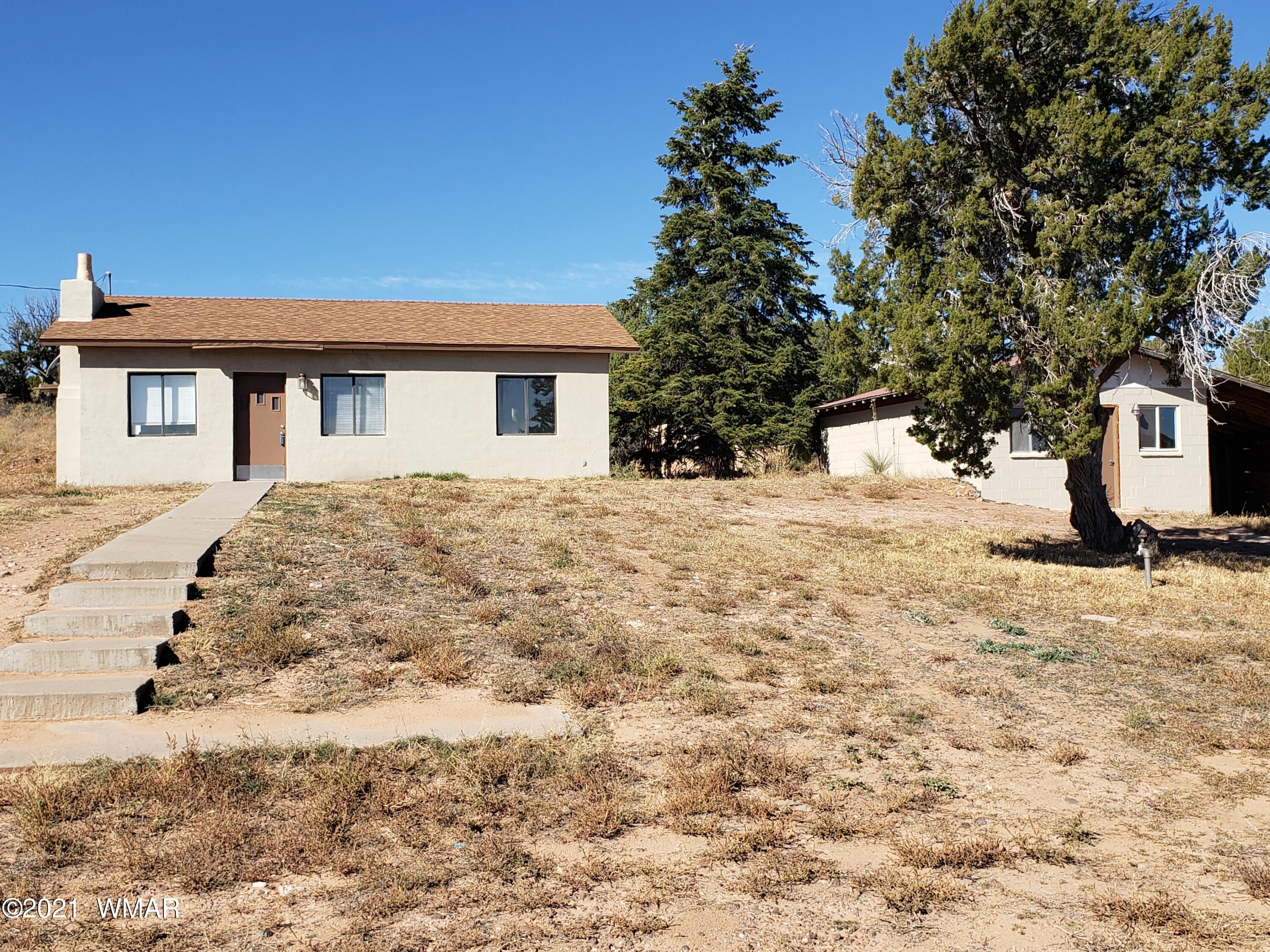 2656 Paper Mill Road Taylor, AZ 85939 - Photo 1 of 14 a front view of a house with a yard