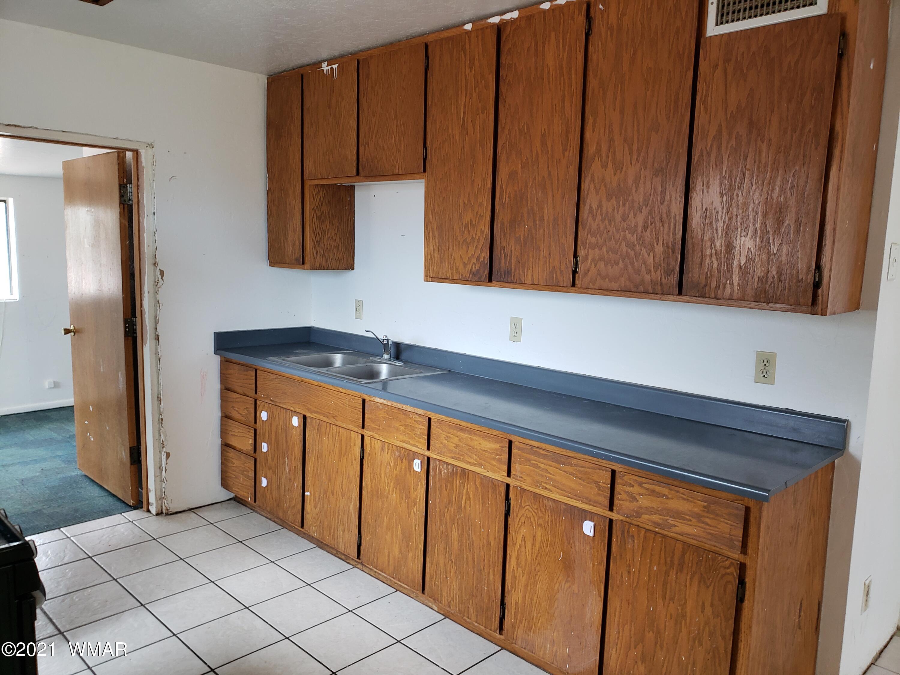2656 Paper Mill Road Taylor, AZ 85939 - Photo 5 of 14 a kitchen with stainless steel appliances granite countertop wooden cabinets a sink and a refrigerator