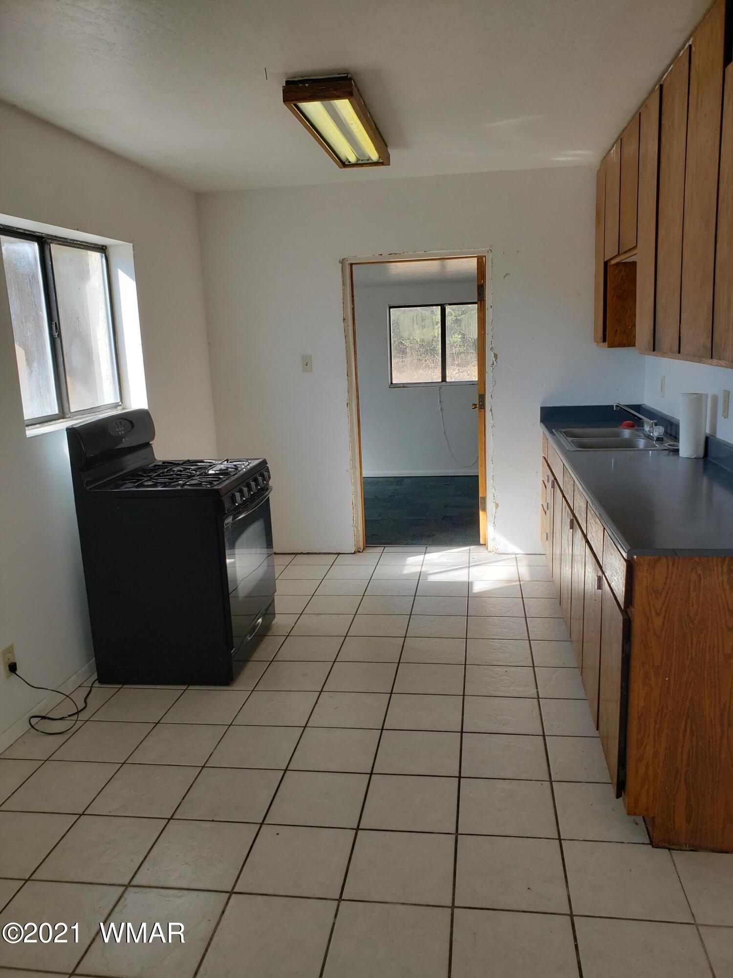 2656 Paper Mill Road Taylor, AZ 85939 - Photo 6 of 14 a kitchen with a cabinets and a stove top oven