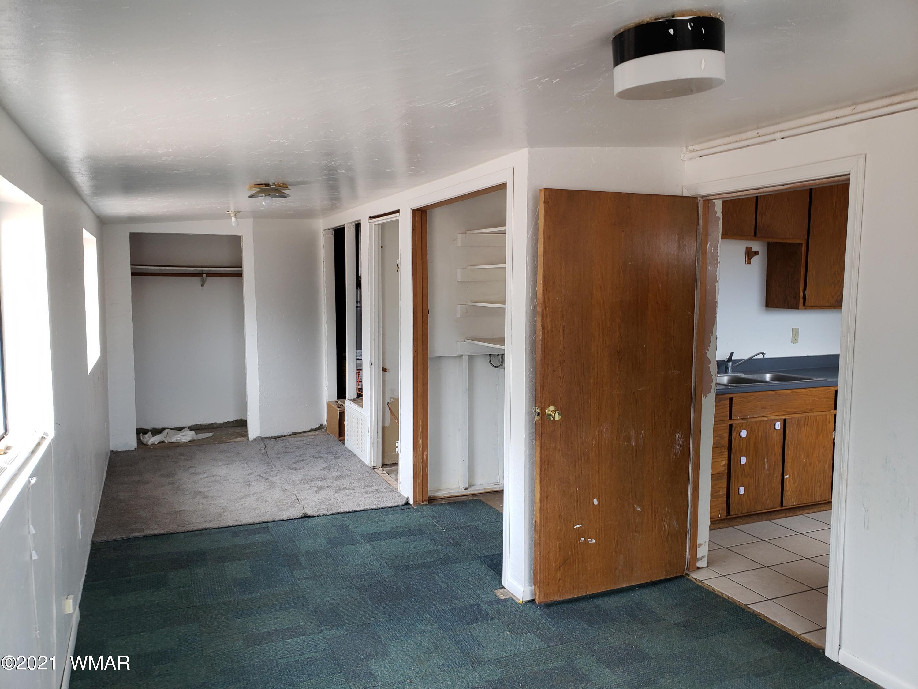 2656 Paper Mill Road Taylor, AZ 85939 - Photo 9 of 14 an empty room with closet and windows