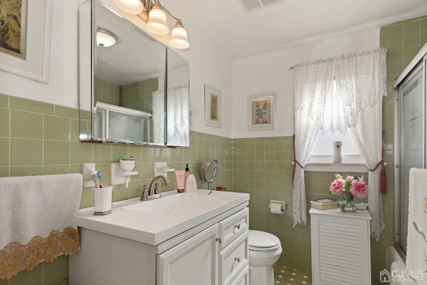 53 Helmetta Road Monroe Township, NJ 08831 - Photo 12 of 30 a bathroom with a sink toilet and a mirror