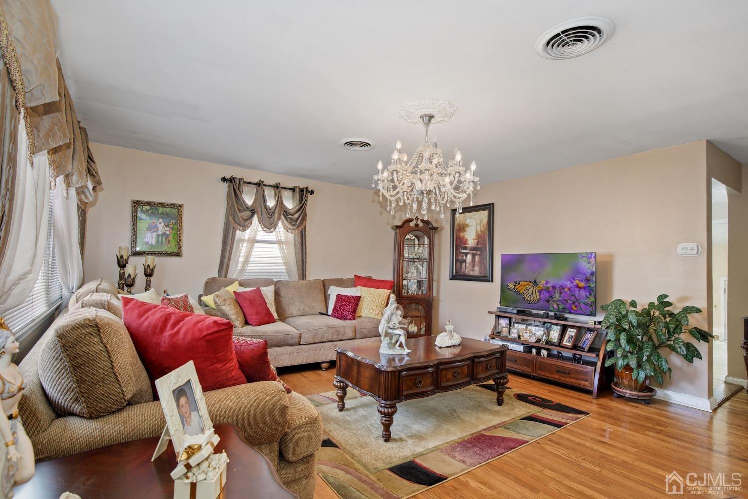 53 Helmetta Road Monroe Township, NJ 08831 - Photo 2 of 30 a living room with furniture chandelier and a flat screen tv