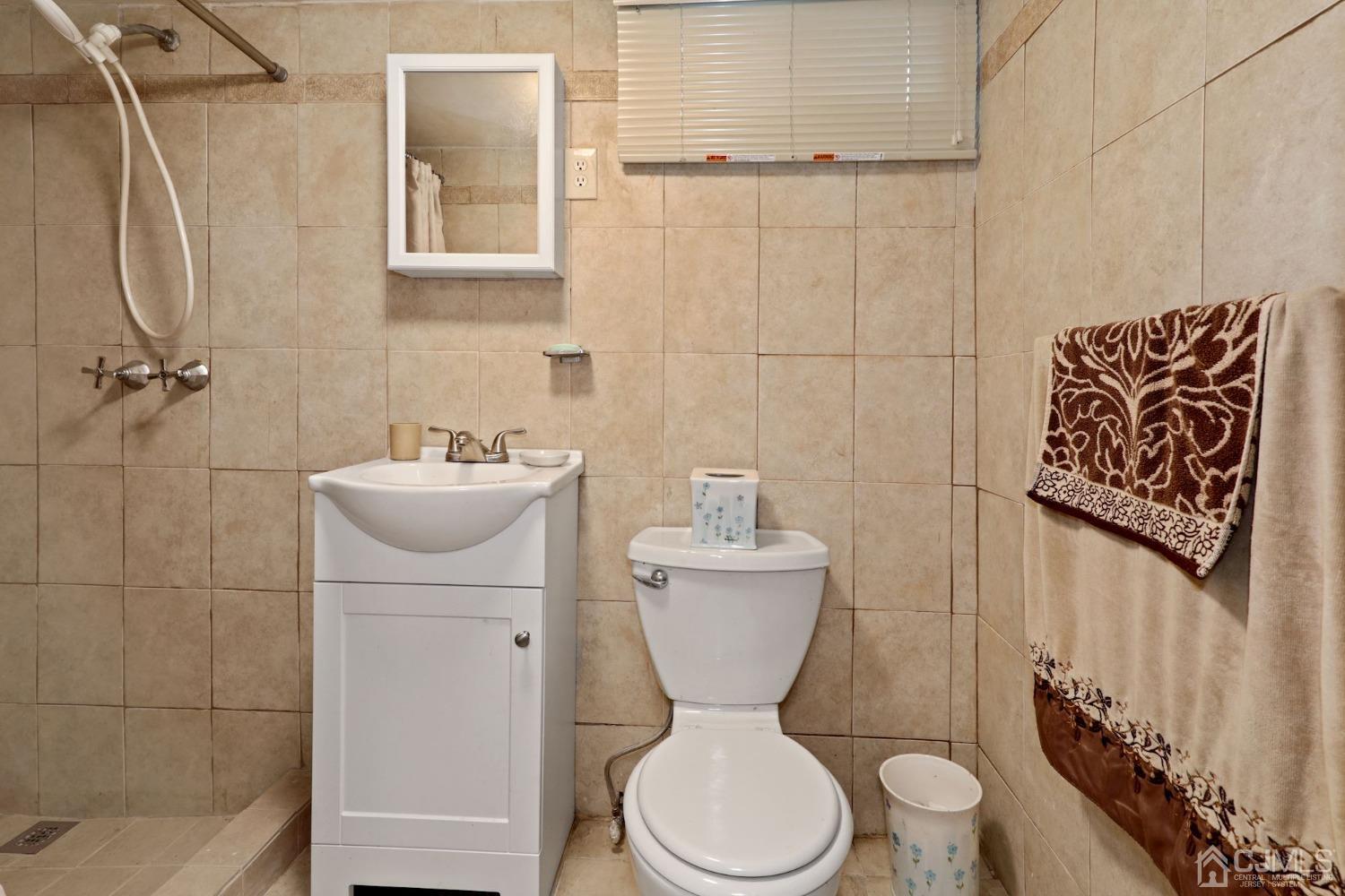53 Helmetta Road Monroe Township, NJ 08831 - Photo 21 of 30 a bathroom with a toilet sink and mirror