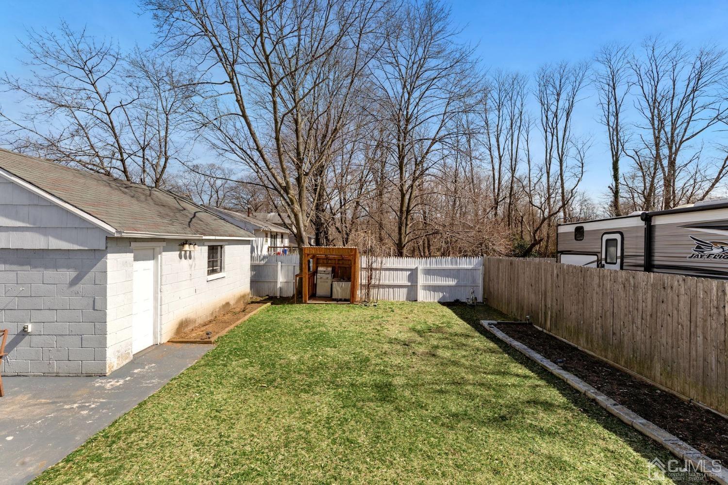 53 Helmetta Road Monroe Township, NJ 08831 - Photo 28 of 30 a view of a backyard with wooden fence