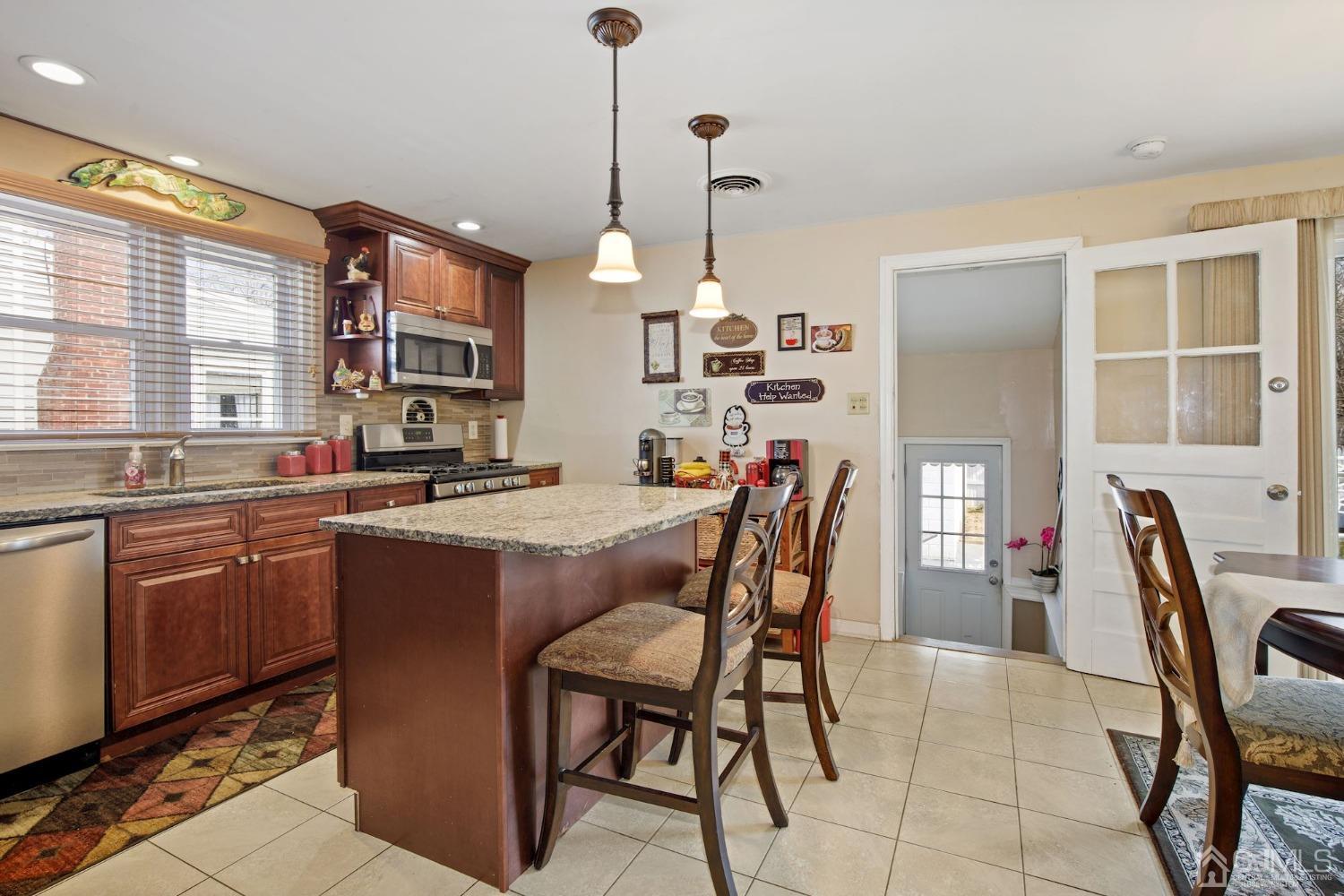 53 Helmetta Road Monroe Township, NJ 08831 - Photo 3 of 30 a dining table with chairs and kitchen view