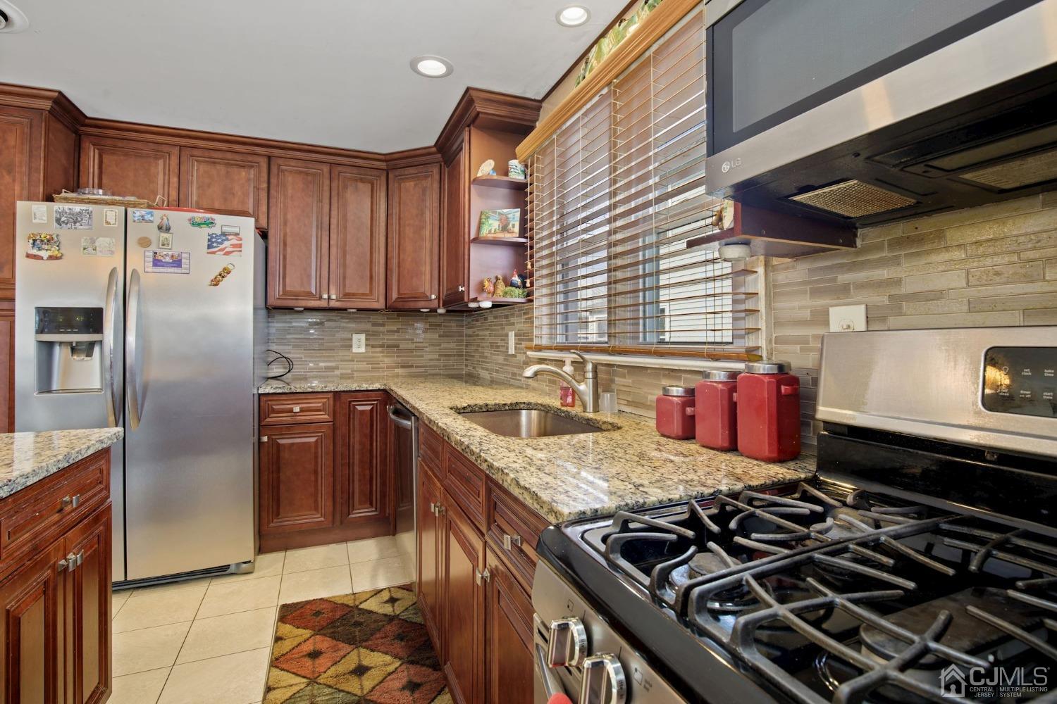 53 Helmetta Road Monroe Township, NJ 08831 - Photo 4 of 30 a kitchen with granite countertop a stove and a sink