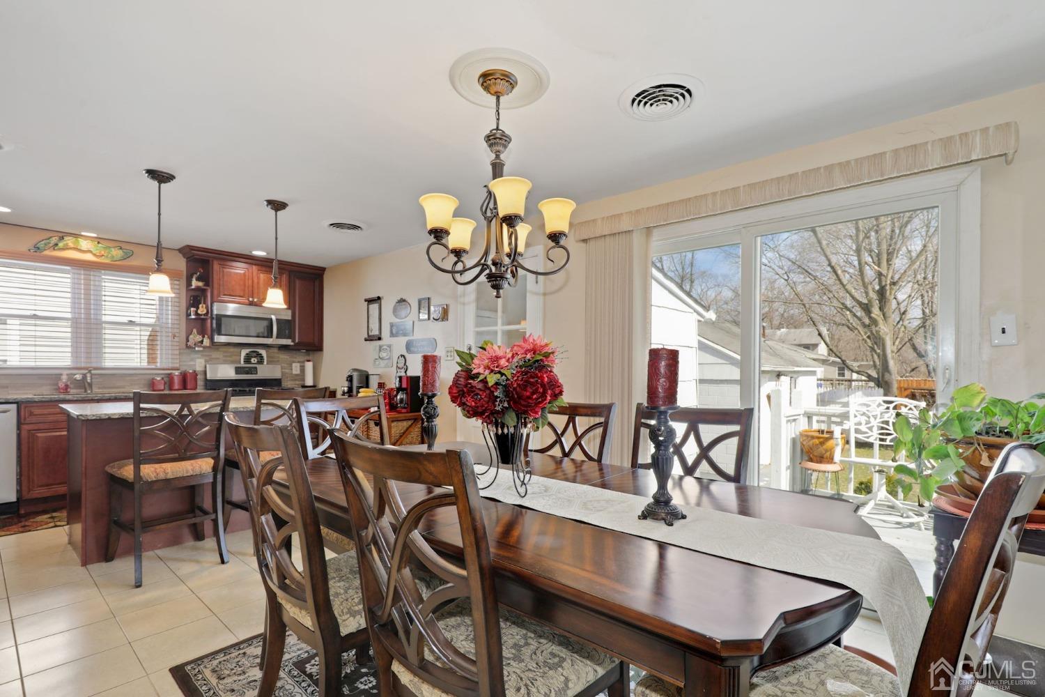 53 Helmetta Road Monroe Township, NJ 08831 - Photo 5 of 30 a view of a dining room with furniture a chandelier and wooden floor