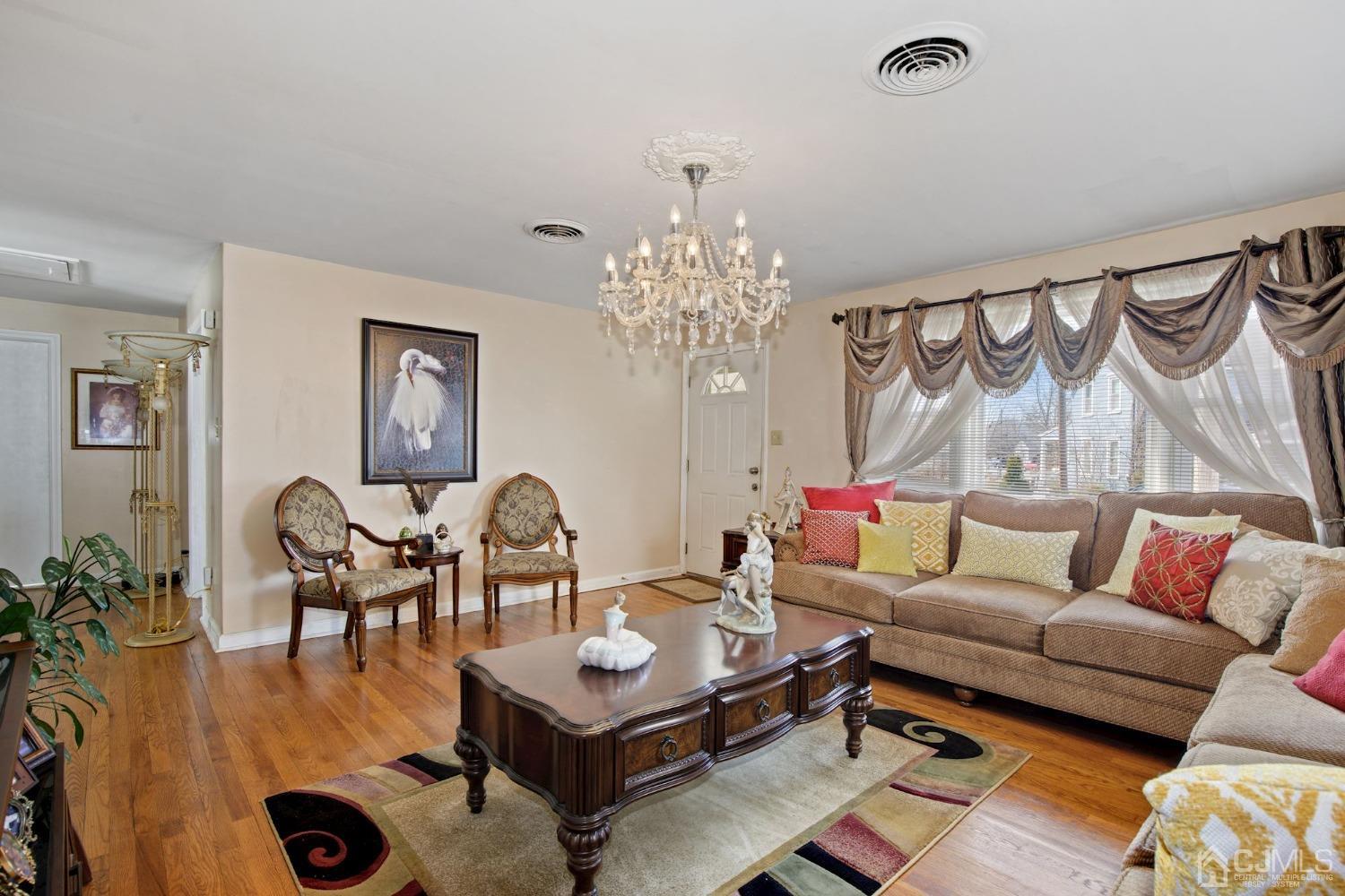 53 Helmetta Road Monroe Township, NJ 08831 - Photo 8 of 30 a living room with furniture and a chandelier