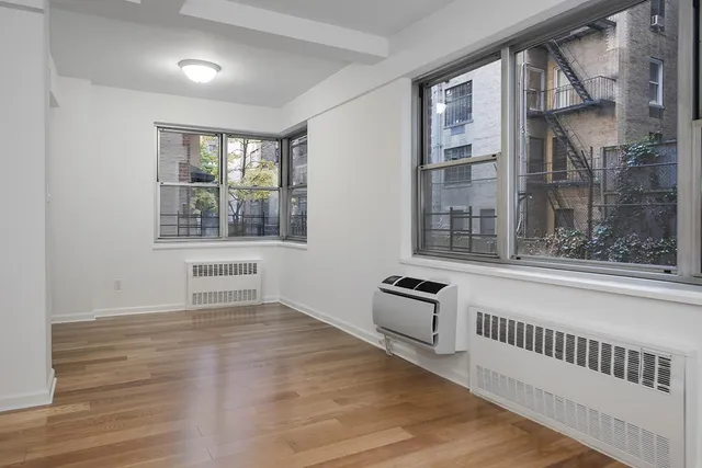 a view of an empty room and wooden floor