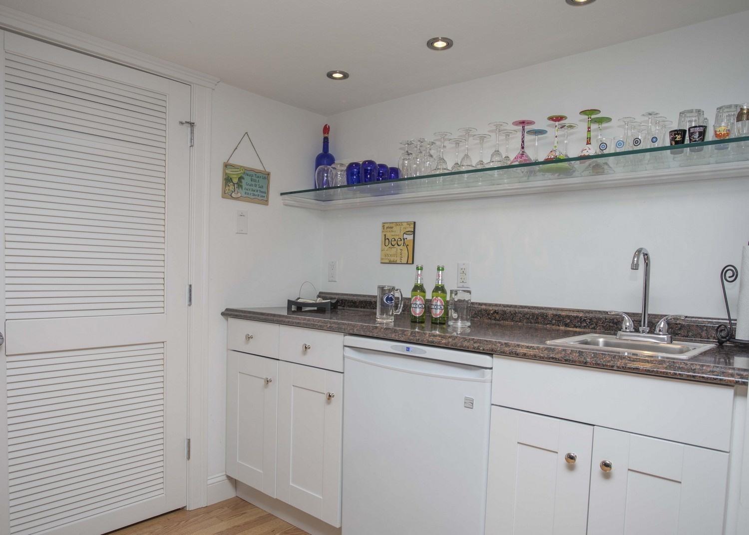 68 Shoestring Bay Road Mashpee, MA 02649 - Photo 22 of 30 a kitchen with stainless steel appliances granite countertop a sink and wooden cabinets