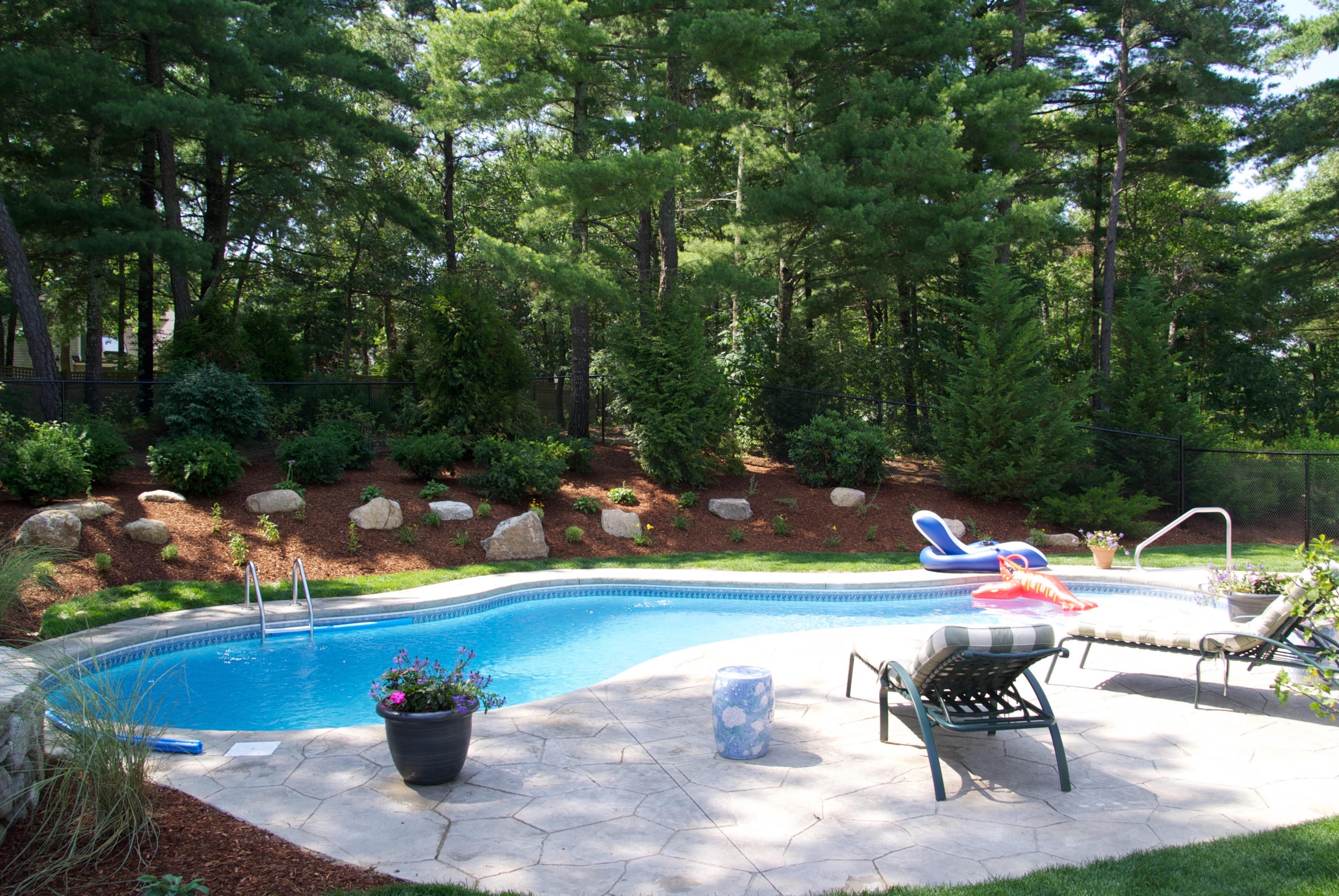 68 Shoestring Bay Road Mashpee, MA 02649 - Photo 25 of 30 a view of a chairs and table in a backyard