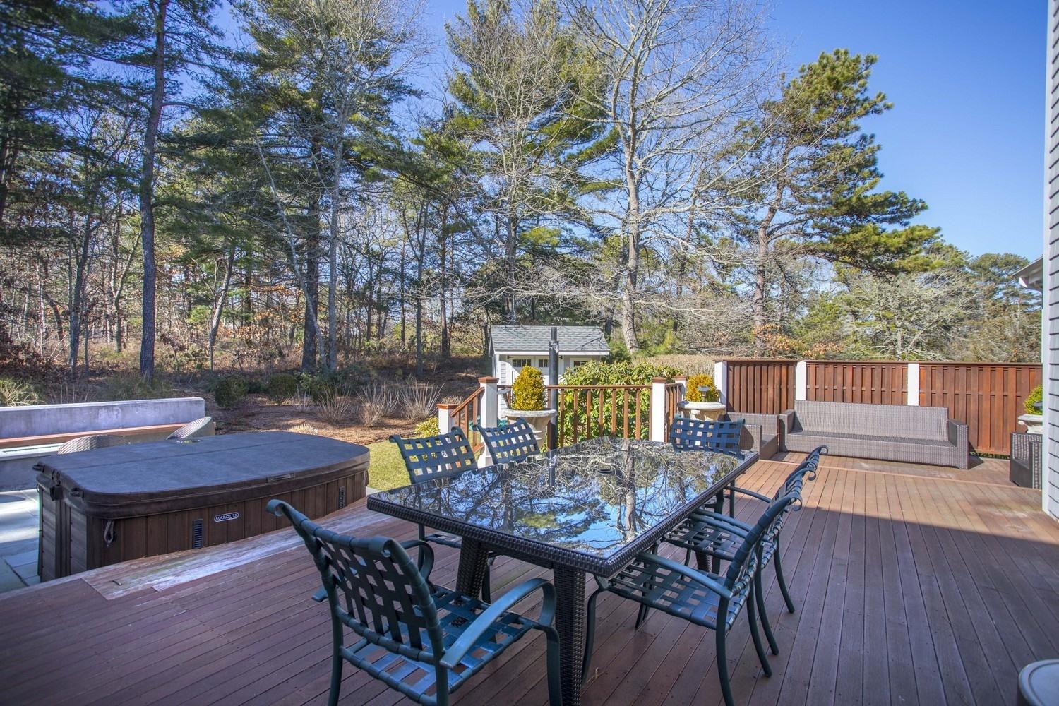 68 Shoestring Bay Road Mashpee, MA 02649 - Photo 27 of 30 a view of a dinning table and chairs in the patio