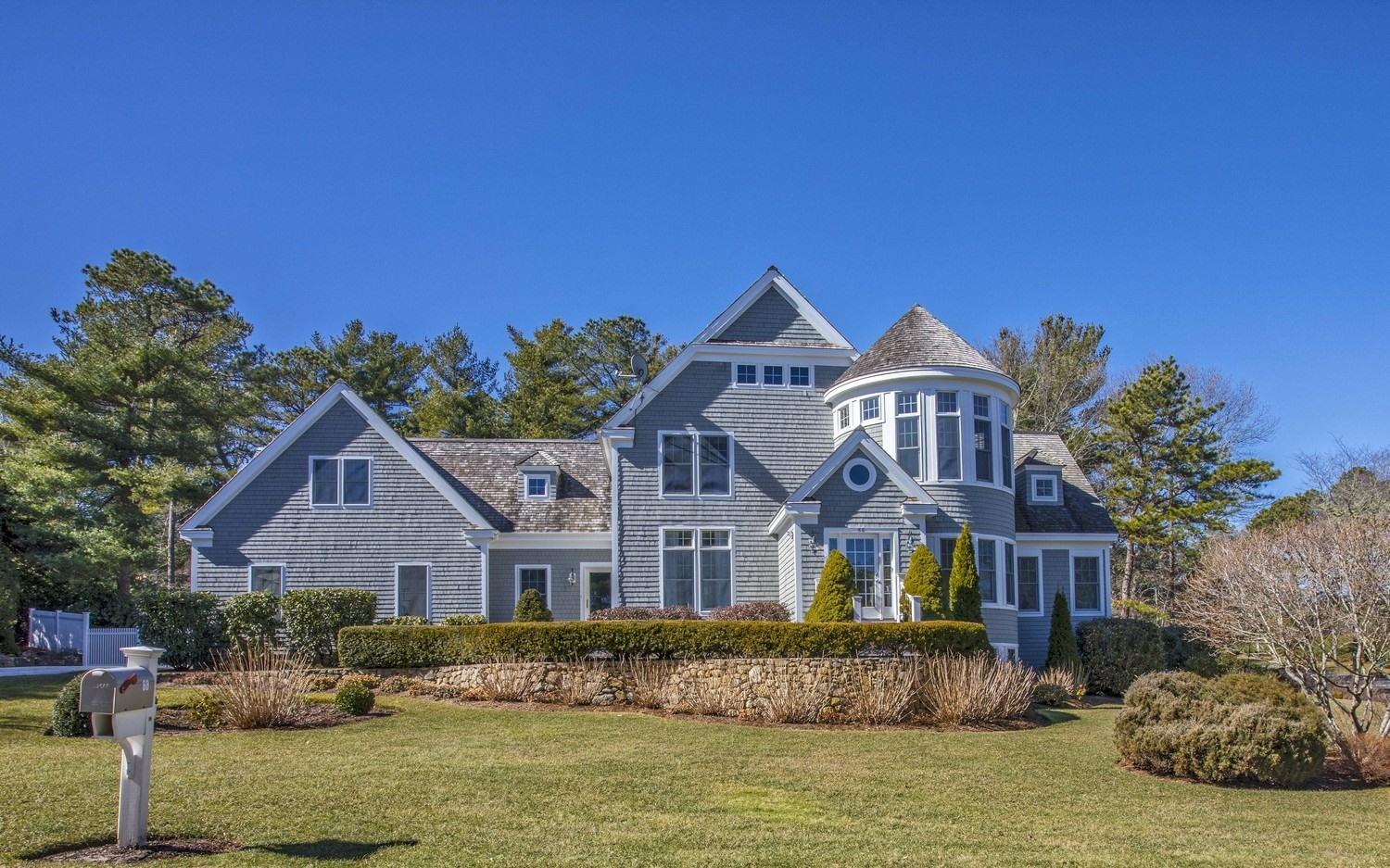 68 Shoestring Bay Road Mashpee, MA 02649 - Photo 28 of 30 a front view of a house with a yard and garage