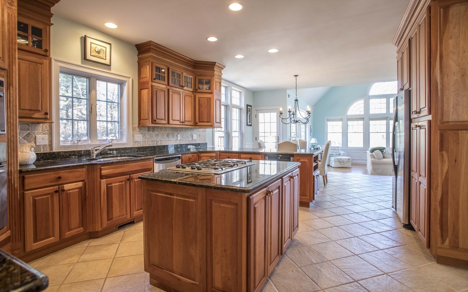 68 Shoestring Bay Road Mashpee, MA 02649 - Photo 5 of 30 a kitchen with a stove sink and cabinets