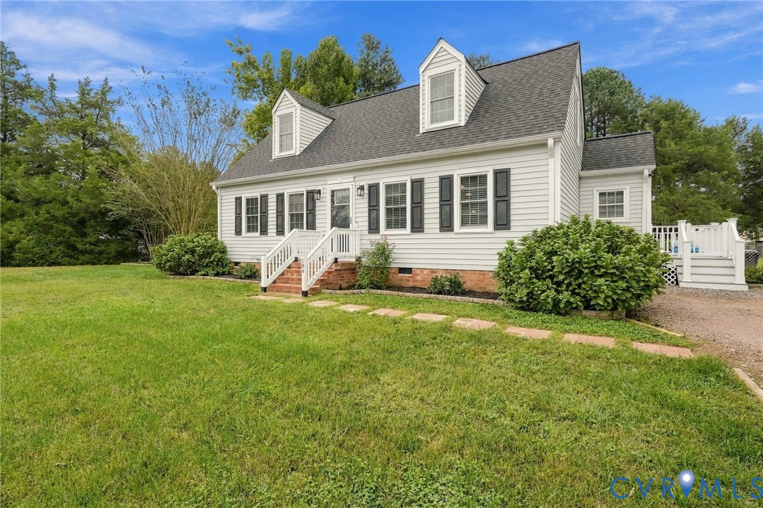 White siding exterior with a dark shingle roof and