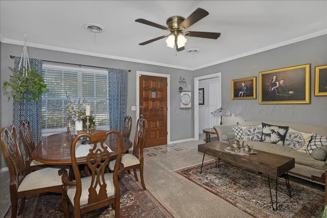 a dining room with furniture and window
