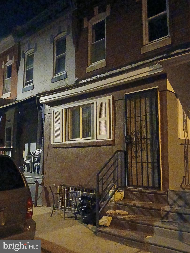 5654 Appletree Street Philadelphia, PA 19139 - Photo 3 of 3 a view of a house with a barbeque and wooden bench