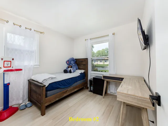 a bed room with a bed and a window