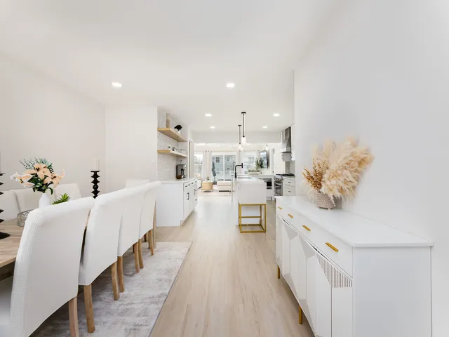a large white kitchen with stainless steel appliances