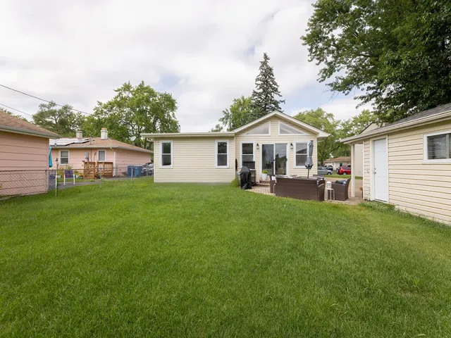 a front view of a house with a yard and trees