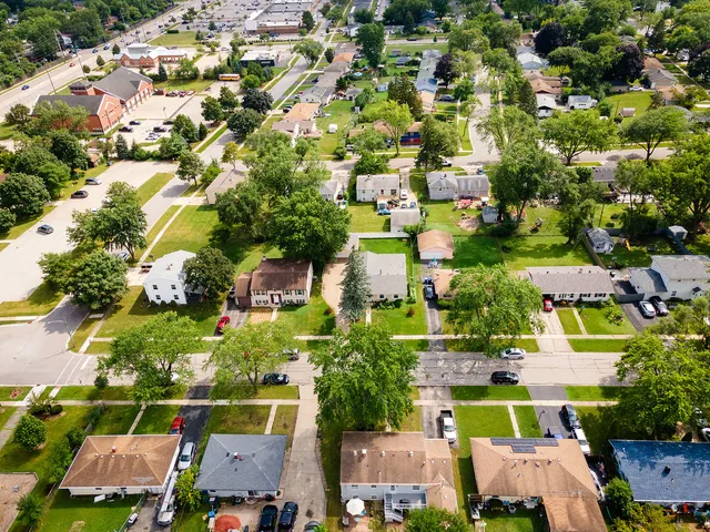 an aerial view of residential houses with outdoor space