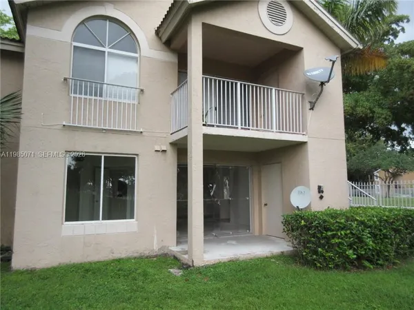 a view of front of a house with a garden