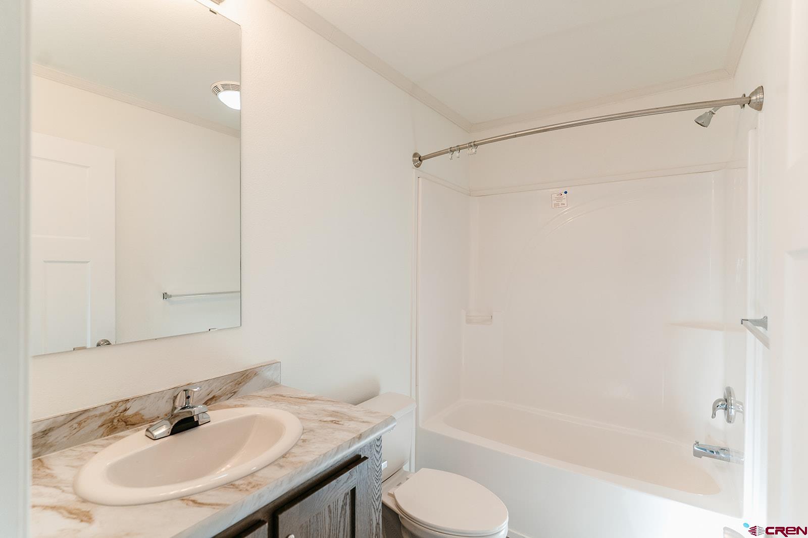 62650 Lasalle Road, Unit 343 Montrose, CO 81403 - Photo 12 of 24 a bathroom with a sink toilet and shower