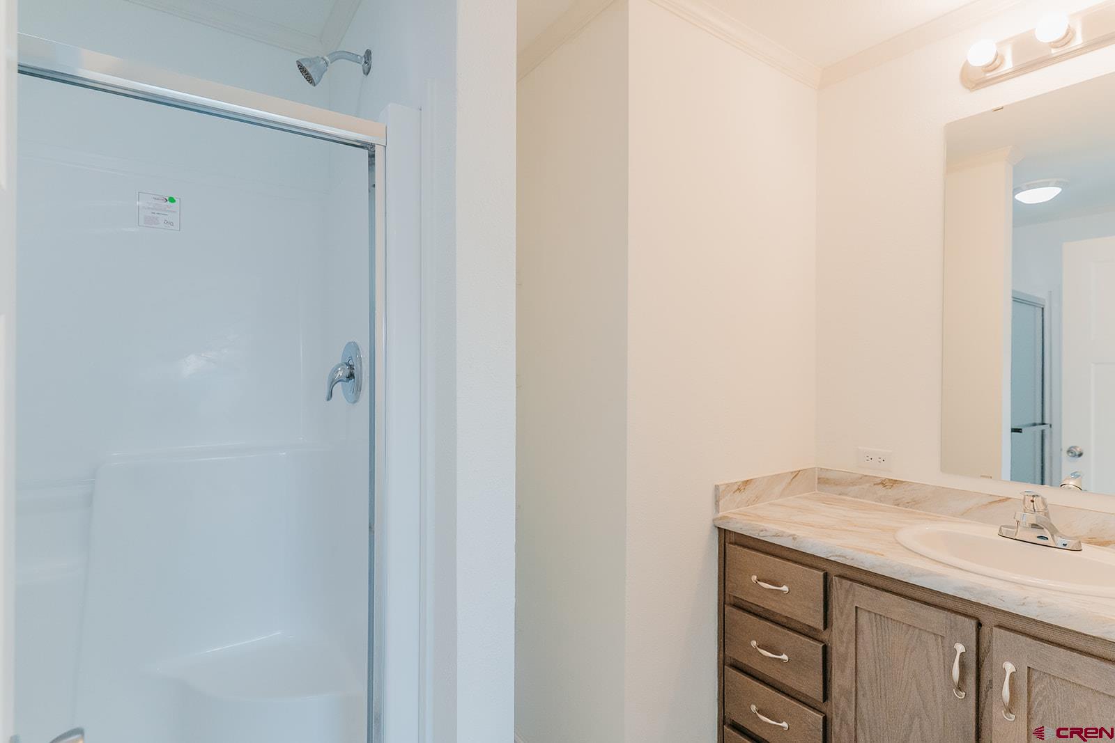 62650 Lasalle Road, Unit 343 Montrose, CO 81403 - Photo 15 of 24 a bathroom with a granite countertop sink and a mirror