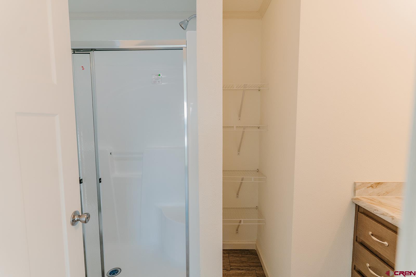 62650 Lasalle Road, Unit 343 Montrose, CO 81403 - Photo 16 of 24 a bathroom with a granite countertop shower and a sink