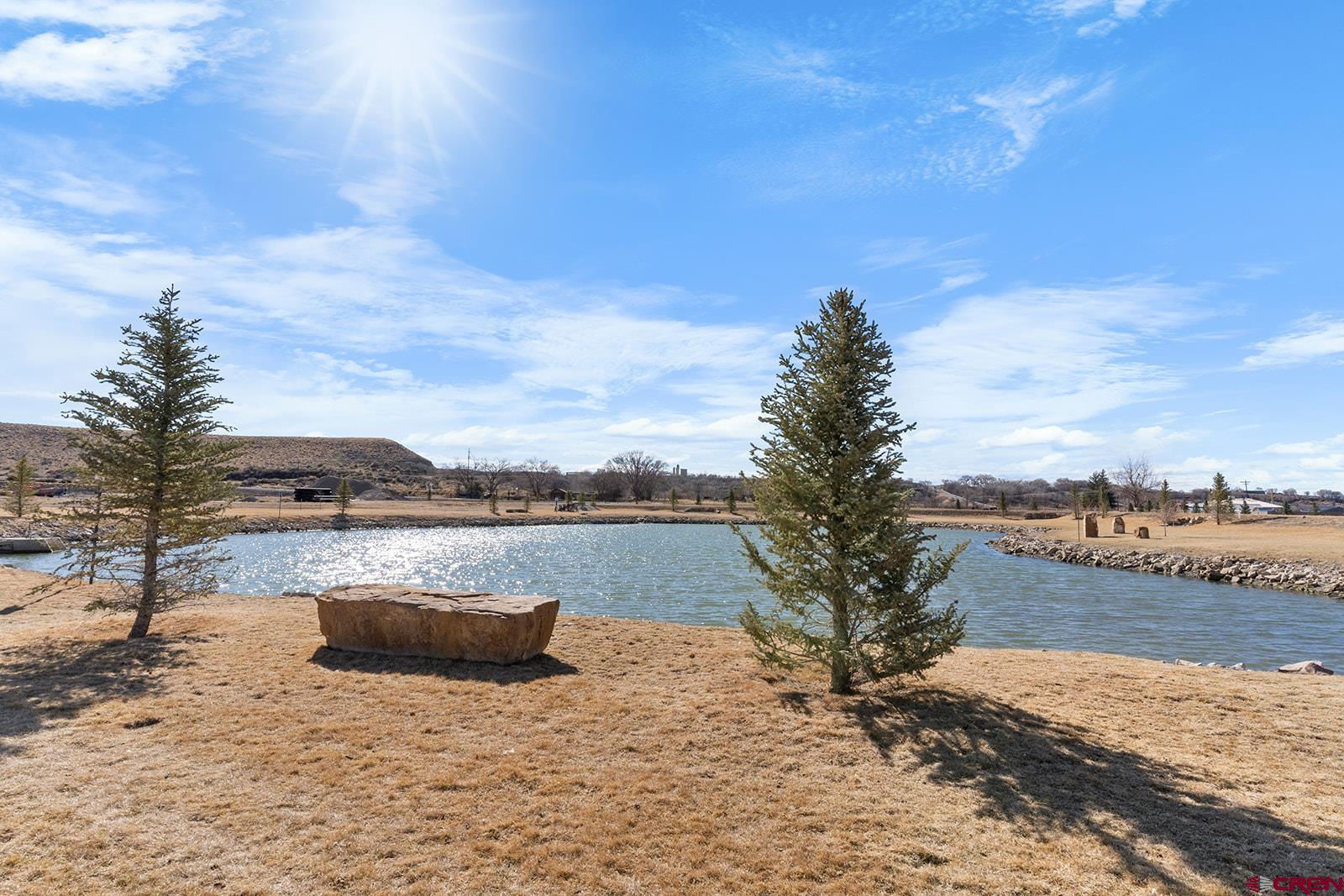 62650 Lasalle Road, Unit 343 Montrose, CO 81403 - Photo 21 of 24 a view of a lake with houses in the back