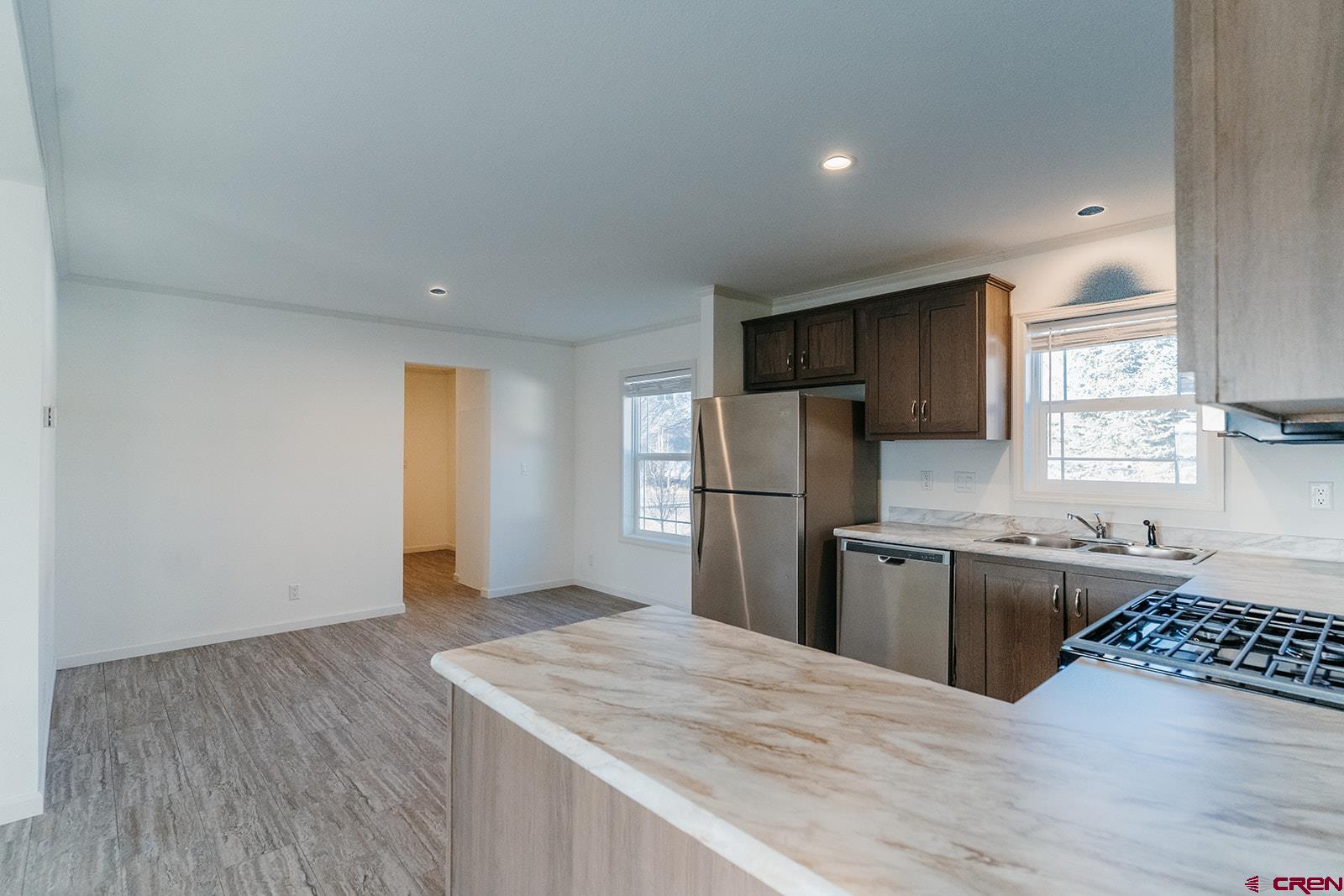 62650 Lasalle Road, Unit 343 Montrose, CO 81403 - Photo 7 of 24 a kitchen with a refrigerator and a stove top oven