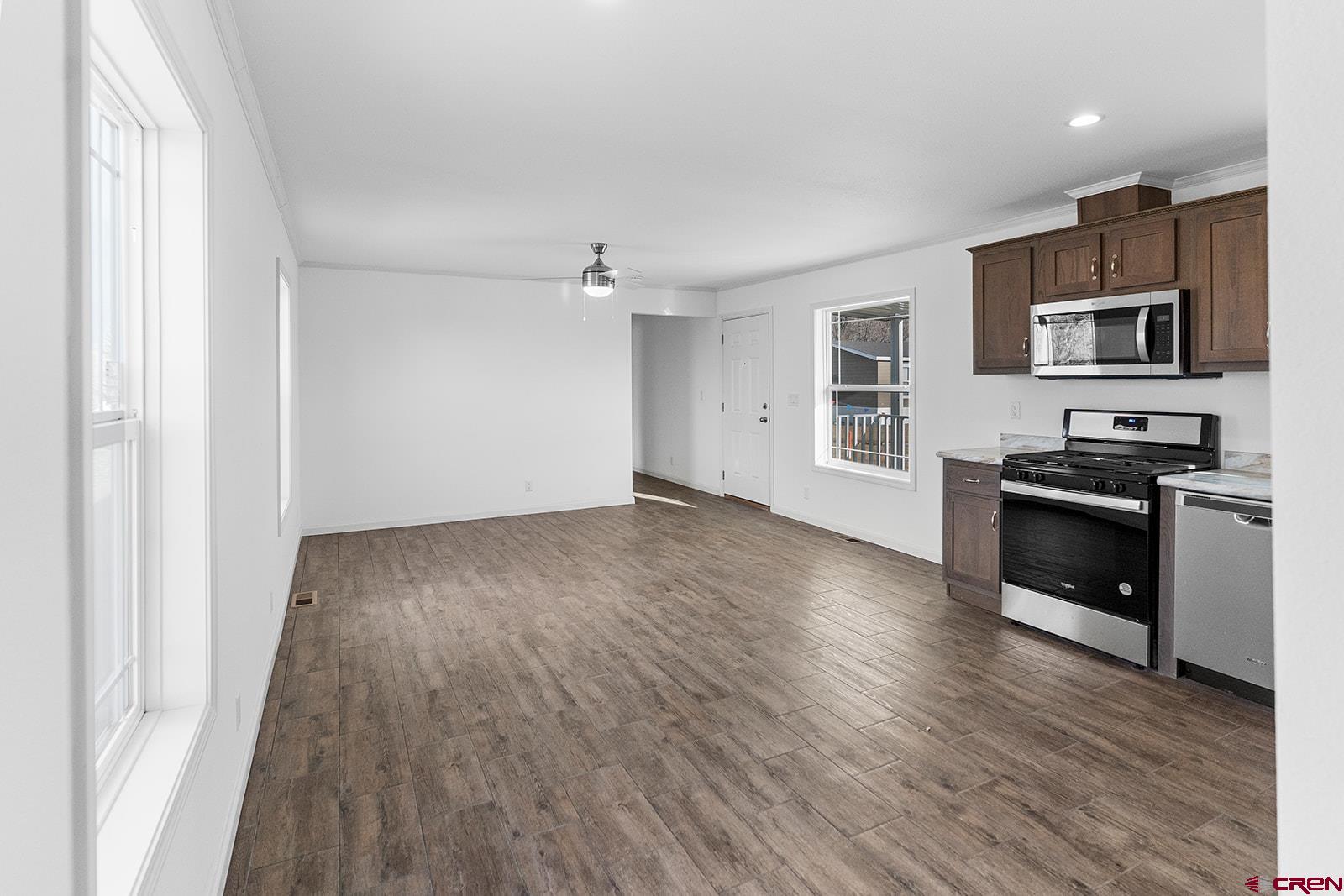 62650 Lasalle Road, Unit 343 Montrose, CO 81403 - Photo 8 of 24 a view of empty room with kitchen and flat screen tv