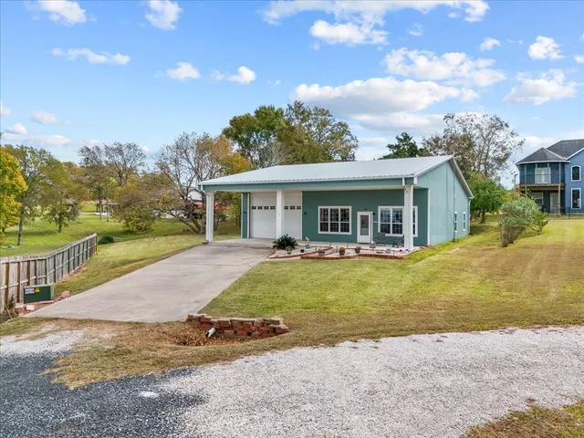 a view of a house with a swimming pool and a yard