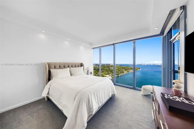 a bedroom with a bed and a couch