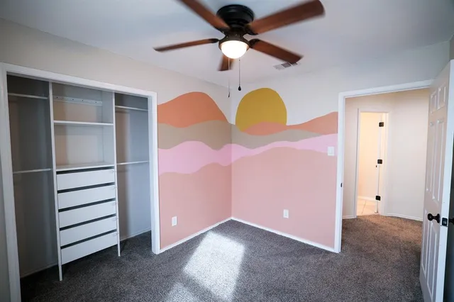 a view of room with a ceiling fan