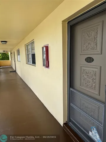 a view of a hallway with paintings on the wall