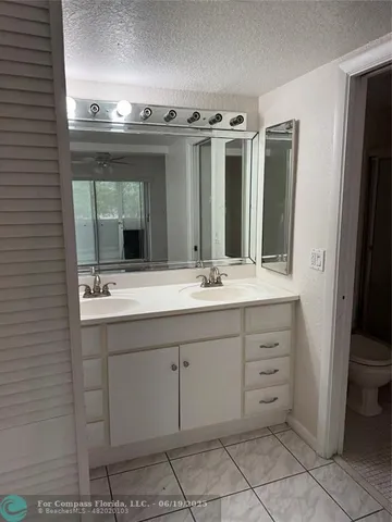 a bathroom with a sink double vanity and a mirror