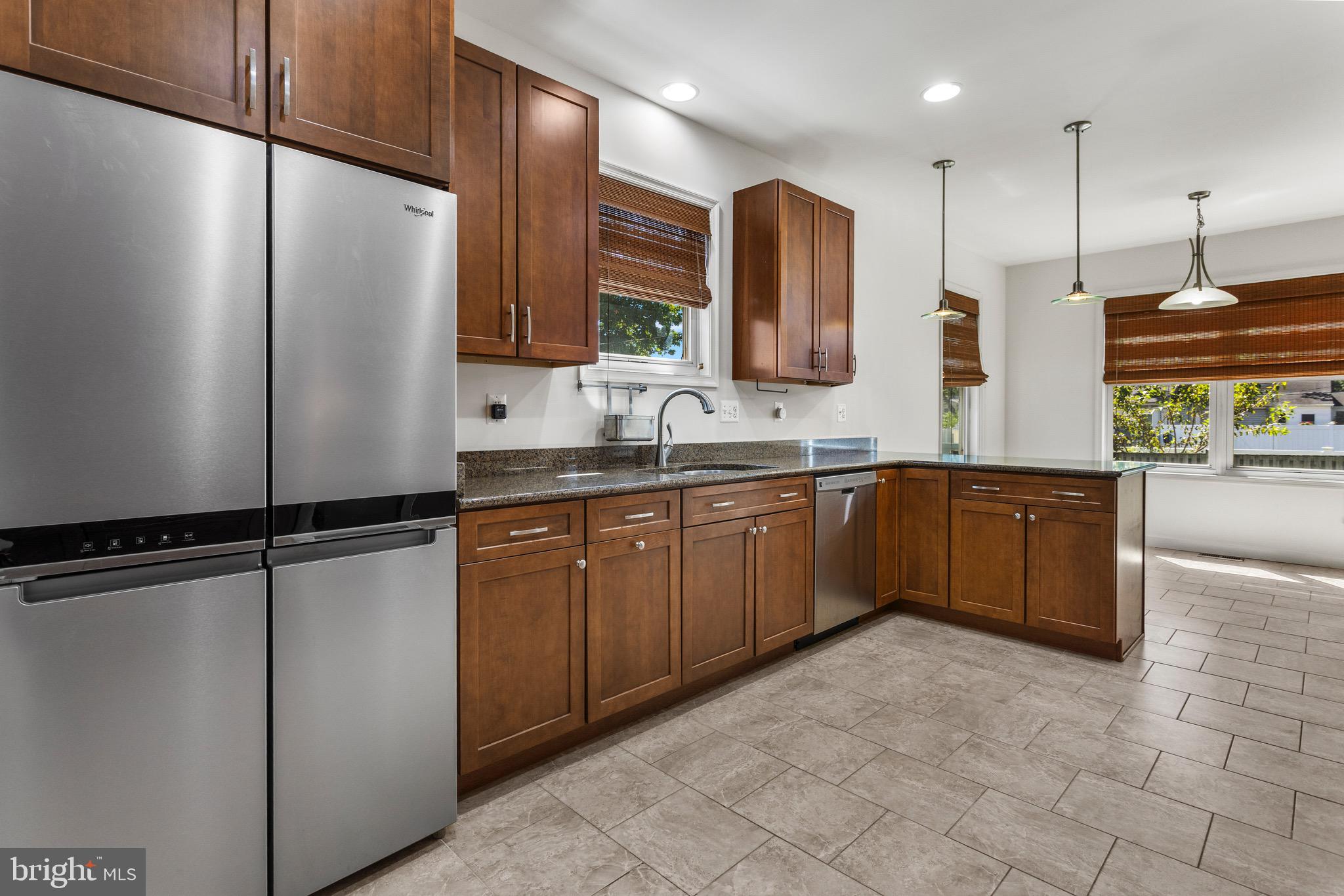 4005 7th Street North Beach, MD 20714 - Photo 7 of 47 a kitchen with stainless steel appliances a refrigerator and a sink