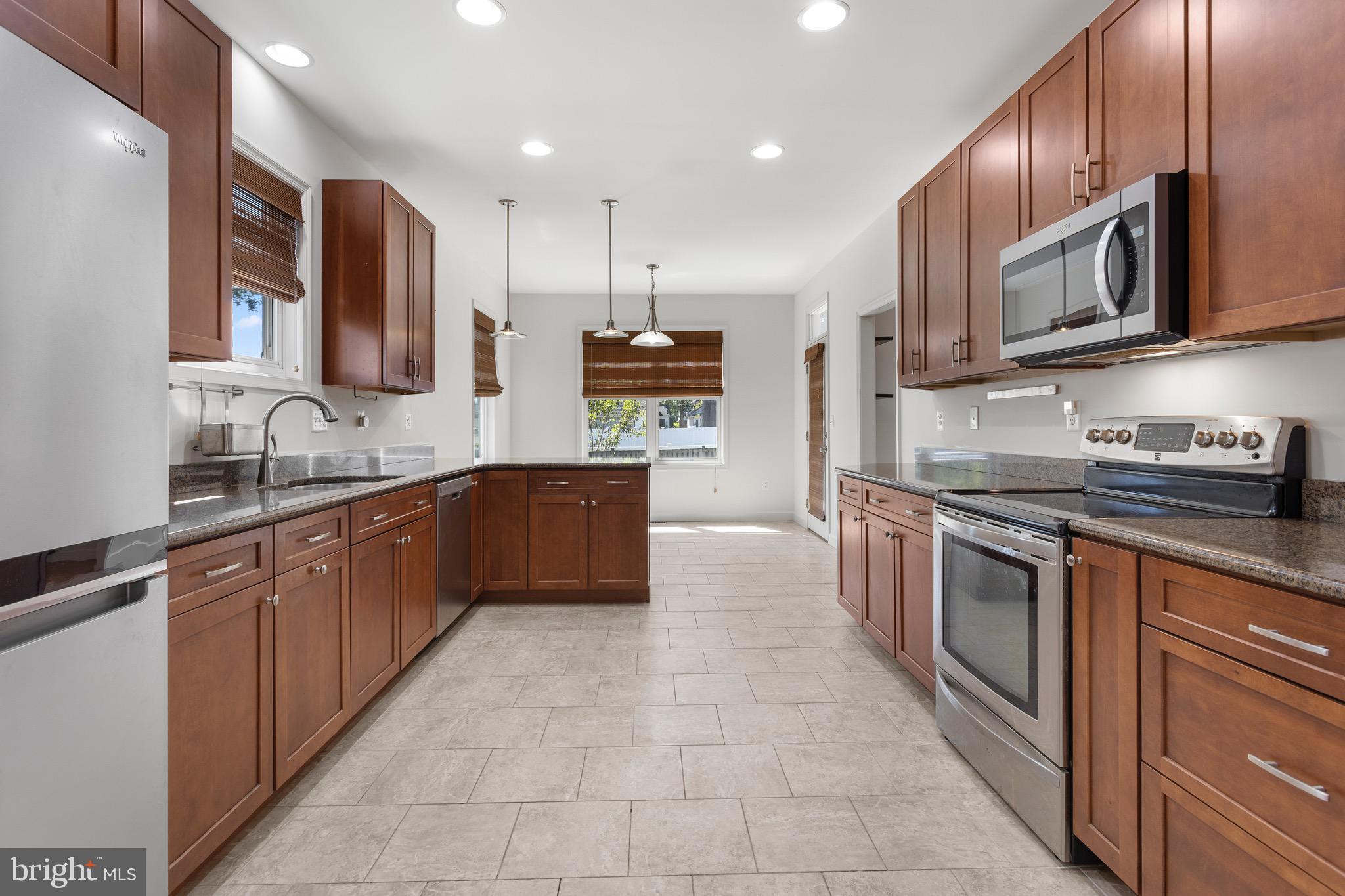 4005 7th Street North Beach, MD 20714 - Photo 8 of 47 a large kitchen with stainless steel appliances lots of counter top space