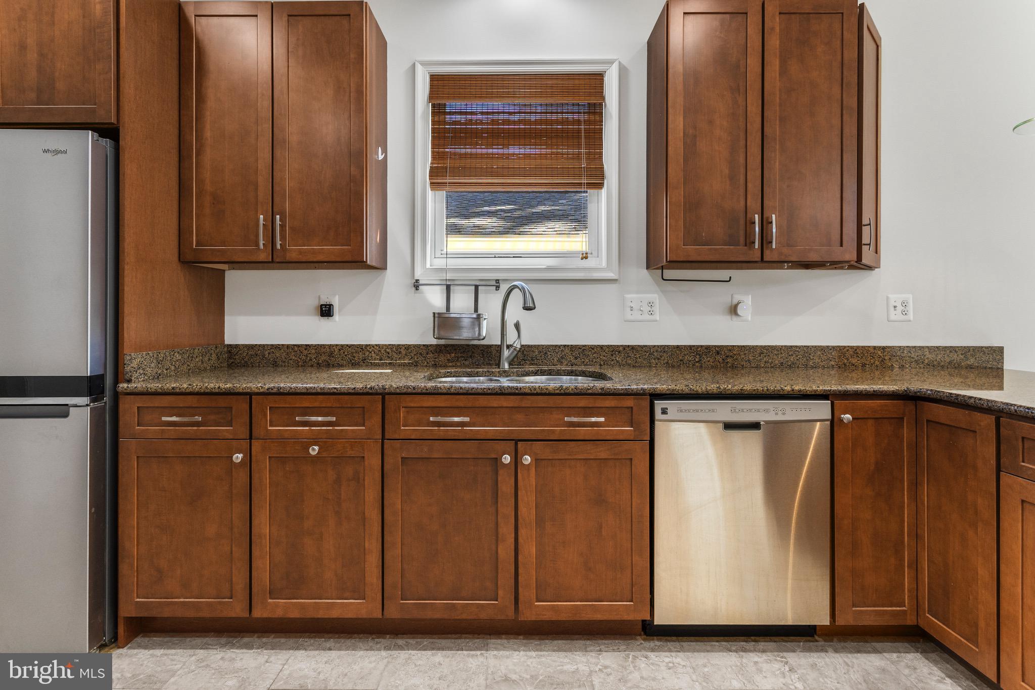 4005 7th Street North Beach, MD 20714 - Photo 10 of 47 a kitchen with stainless steel appliances granite countertop a sink and a cabinets