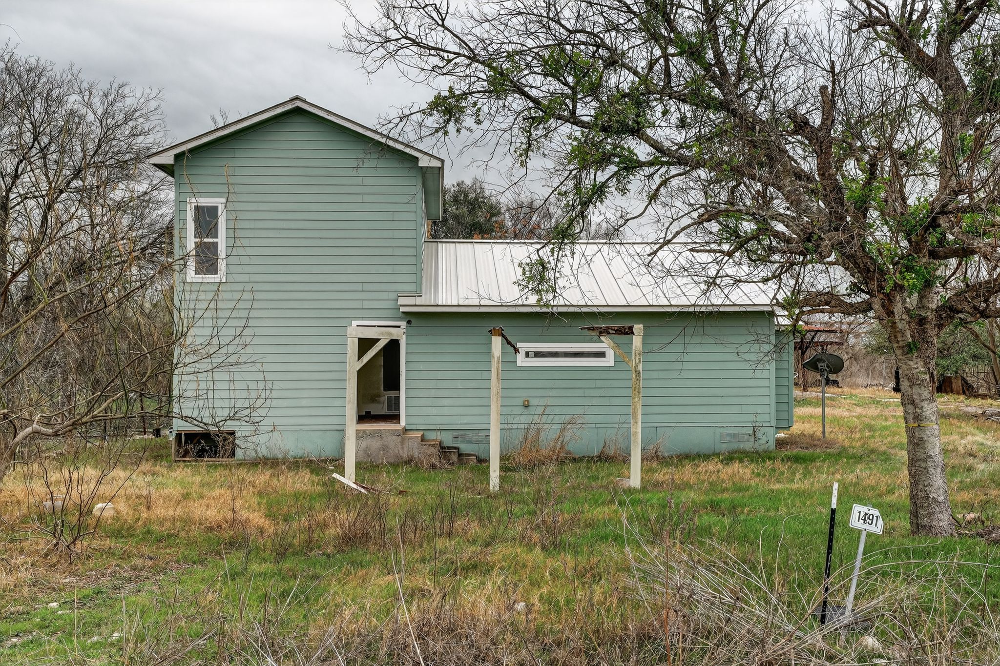 11223 Tom Sassman Road Austin, TX 78747 - Photo 11 of 40 Rear view of property with a metal roof