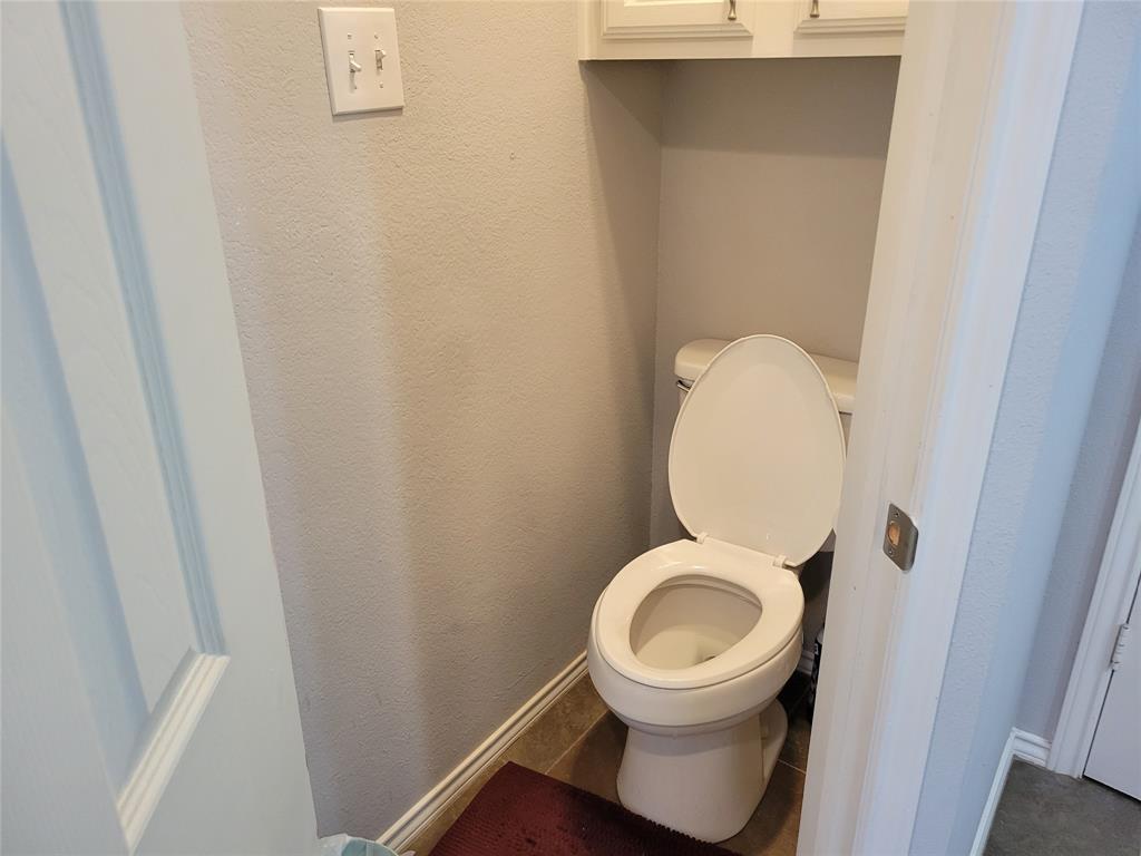 5565 Preston Oaks Road, Unit 117 Dallas, TX 75254 - Photo 13 of 24 a close view of a toilet in a bathroom