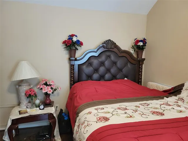 a bedroom with a bed and a dresser