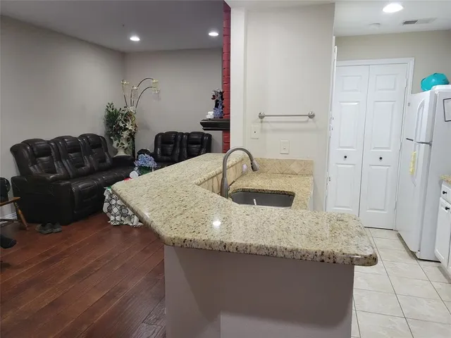 a kitchen with granite countertop a sink and a stove