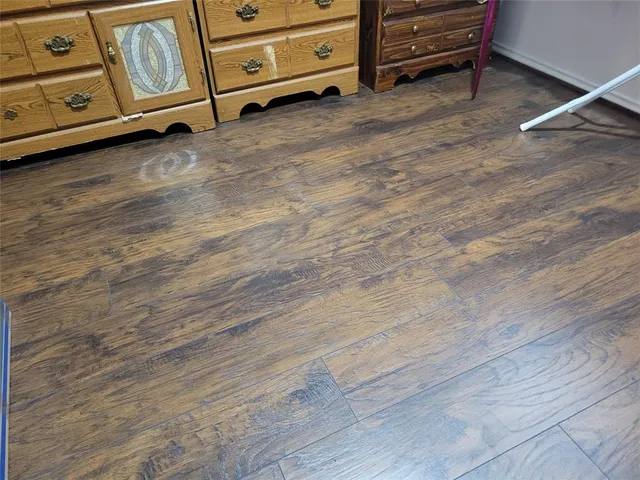 a view of a room with wooden floor