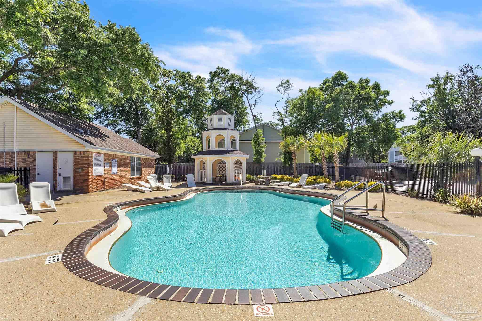 a view of a swimming pool with chairs