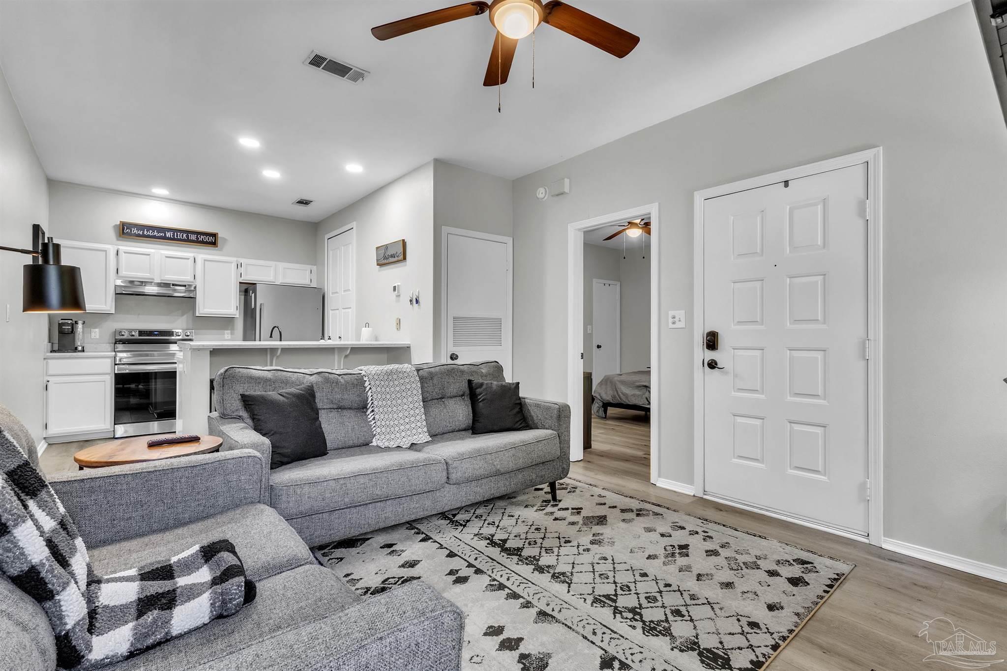 501 East Burgess Road, Unit F5 Pensacola, FL 32504 - Photo 11 of 12 a living room with furniture and a rug