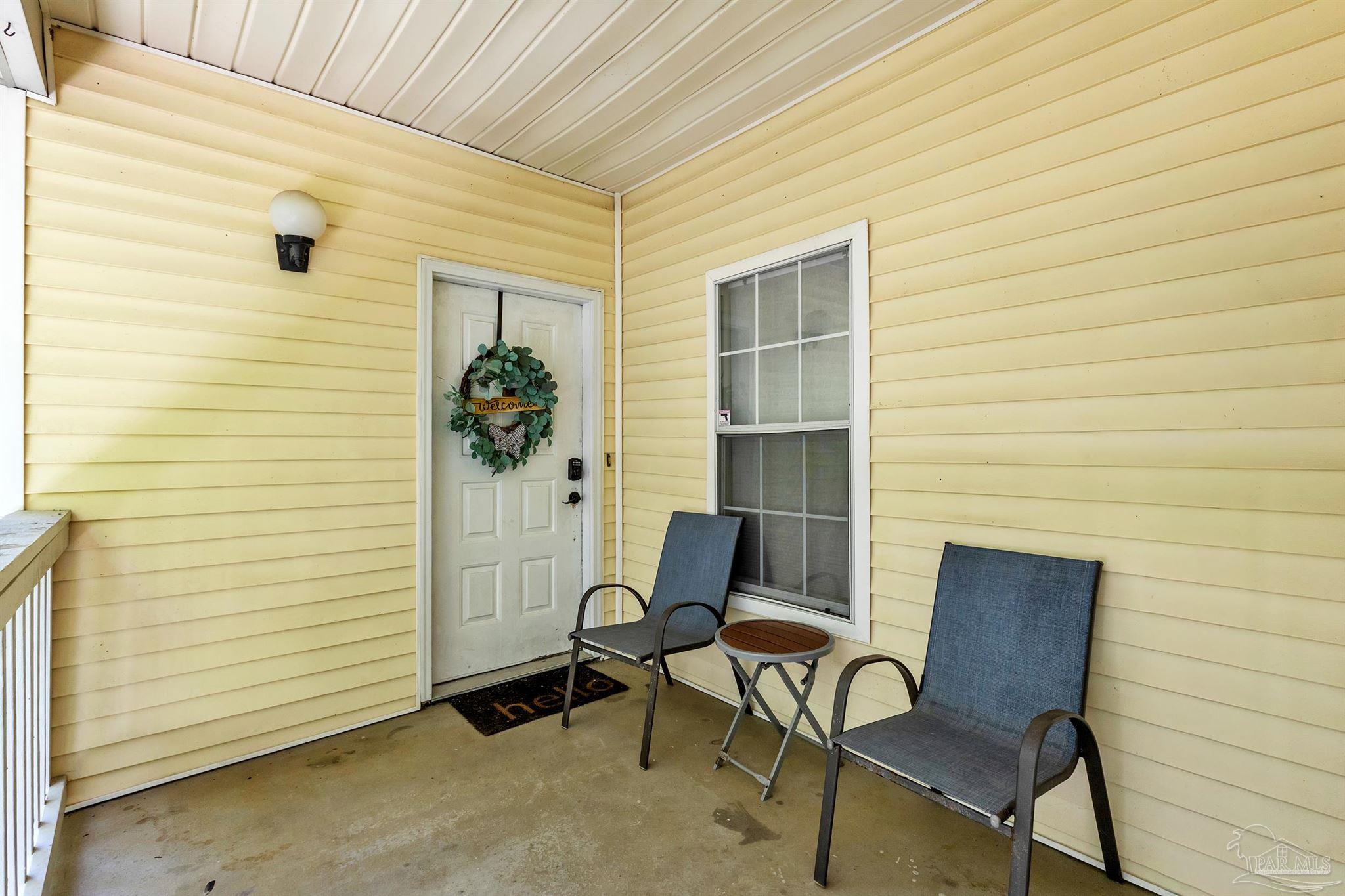 501 East Burgess Road, Unit F5 Pensacola, FL 32504 - Photo 3 of 12 a view of a door and chair in front of house
