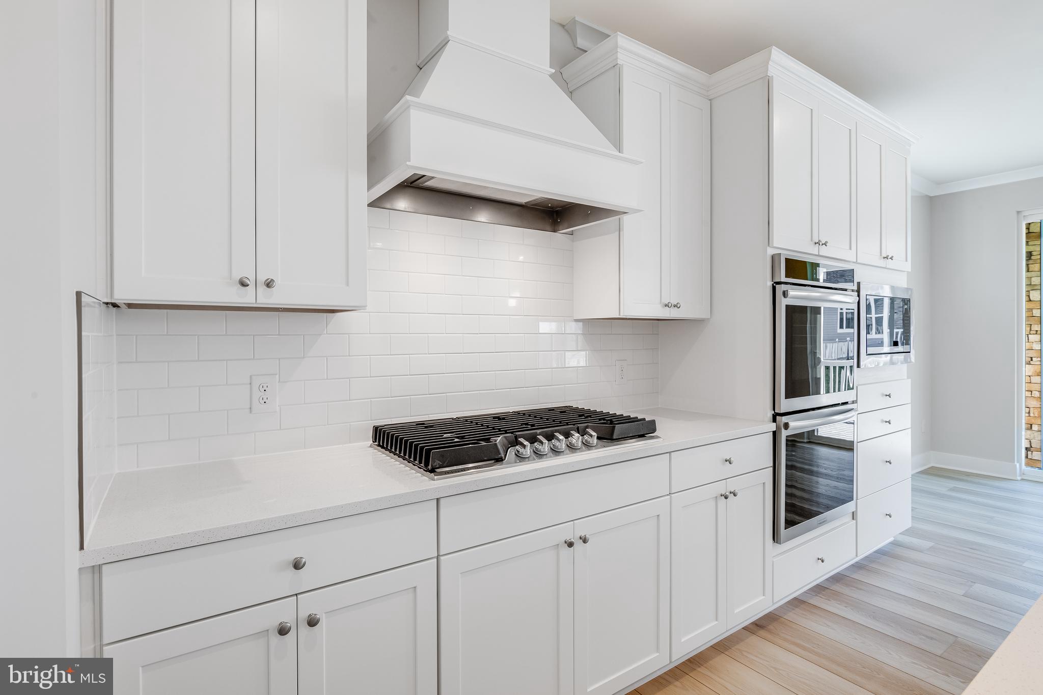 201 Mariners Circle Milton, DE 19968 - Photo 8 of 39 a kitchen with white cabinets and appliances